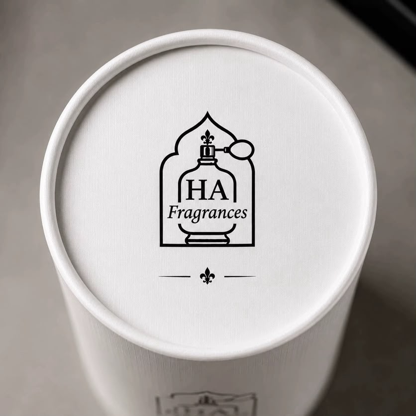Top lid detail of the HA Fragrances packaging with the engraved-style HA Fragrances bottle logo and fleur-de-lis flourish.